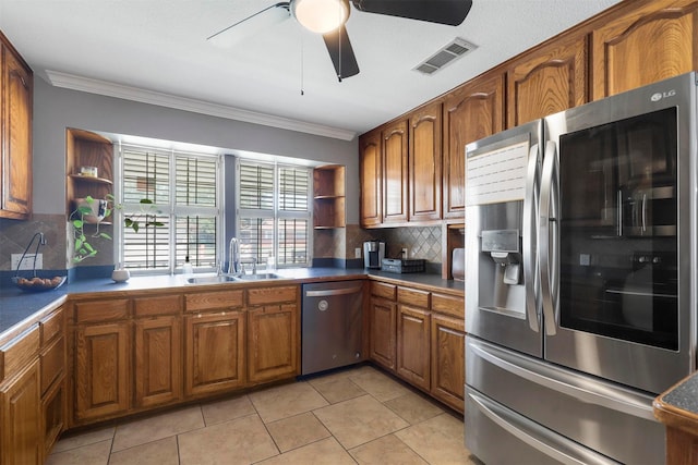 kitchen featuring sink, decorative backsplash, ornamental molding, and stainless steel appliances