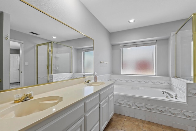 bathroom featuring vanity, tile patterned floors, and plus walk in shower