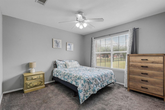 bedroom with ceiling fan and dark colored carpet