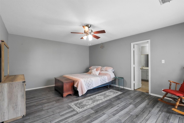 bedroom featuring ceiling fan, dark hardwood / wood-style floors, and ensuite bath