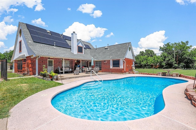 view of pool with a yard and a patio area