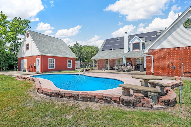 view of pool featuring a yard and a patio area