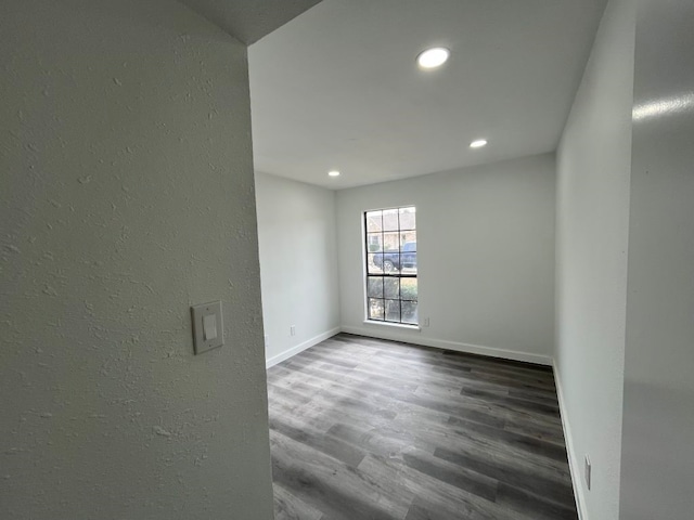 unfurnished room with dark hardwood / wood-style floors