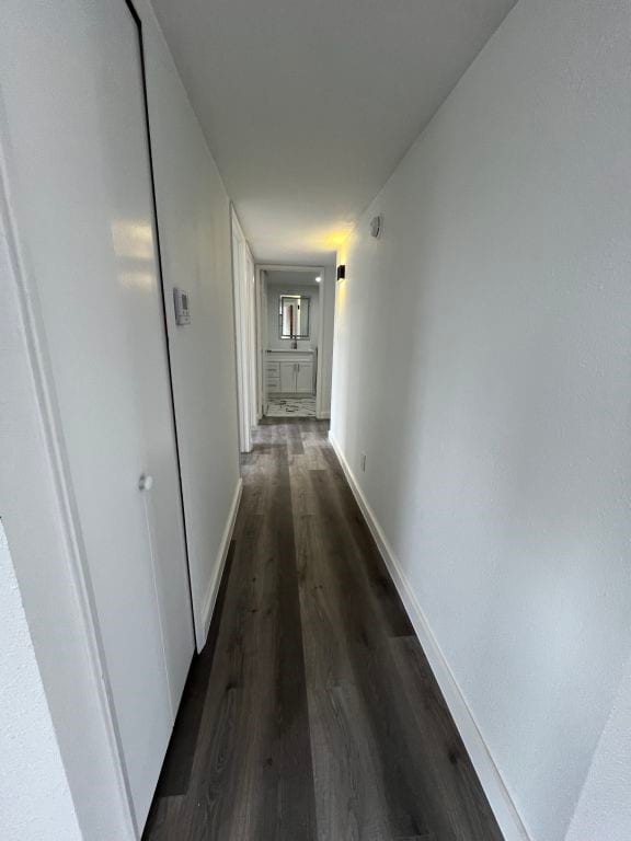 corridor with dark wood-type flooring