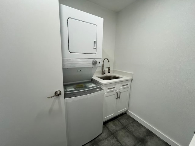 laundry room featuring stacked washing maching and dryer and sink