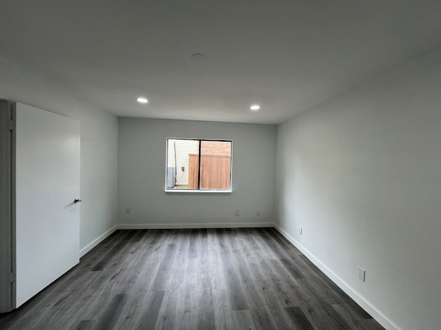 empty room with dark wood-type flooring