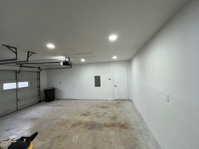 garage with a garage door opener and electric panel