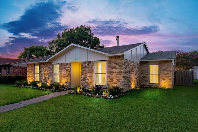 ranch-style home with a lawn