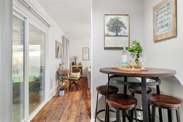 dining room featuring ornamental molding and hardwood / wood-style floors