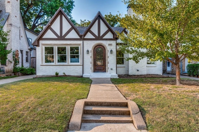 tudor-style house with a front lawn