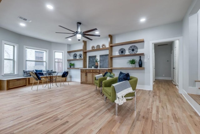 living area featuring ceiling fan and light hardwood / wood-style floors