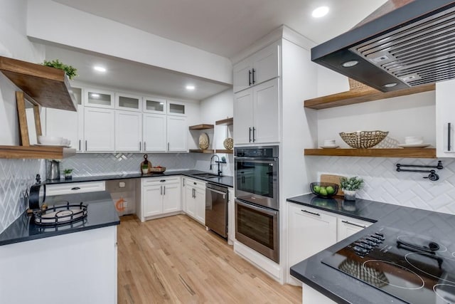 kitchen with white cabinetry, sink, and wall chimney exhaust hood