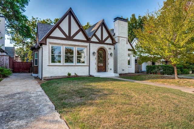 tudor home featuring a front yard