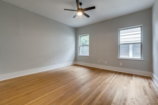 empty room with ceiling fan and light hardwood / wood-style floors