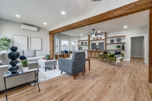 living room with beam ceiling, an AC wall unit, ceiling fan, and light wood-type flooring