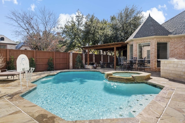 view of swimming pool featuring a patio area and an in ground hot tub