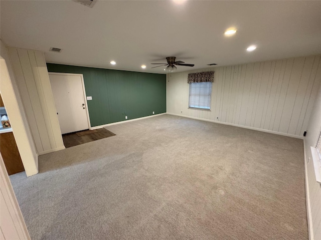 carpeted spare room featuring ceiling fan