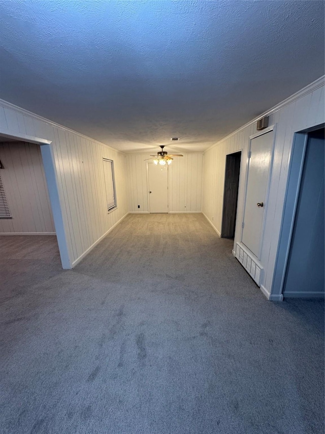 interior space featuring a textured ceiling, carpet floors, and ceiling fan