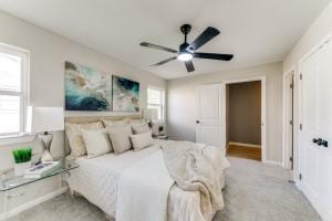 bedroom with ceiling fan and light carpet