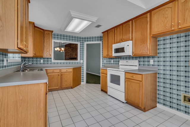 kitchen featuring sink, light tile patterned floors, a notable chandelier, and white appliances