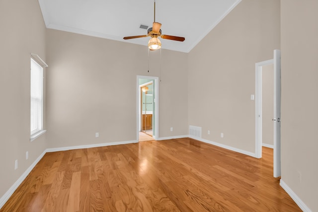 unfurnished room featuring crown molding, high vaulted ceiling, ceiling fan, and light hardwood / wood-style floors