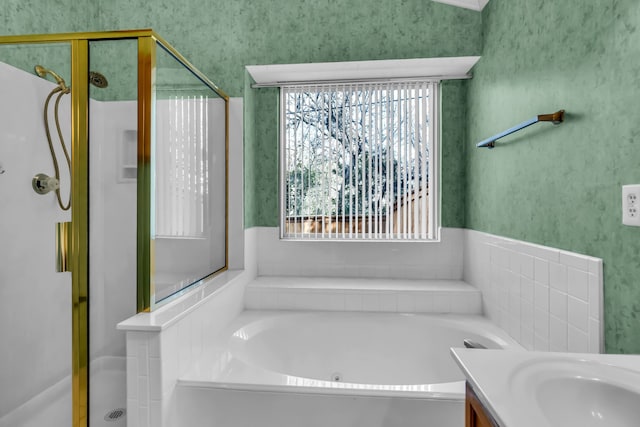 bathroom featuring vanity, plenty of natural light, and plus walk in shower