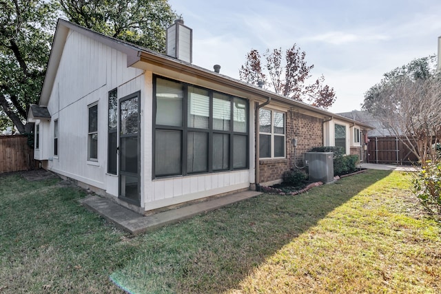 view of home's exterior with central AC and a lawn