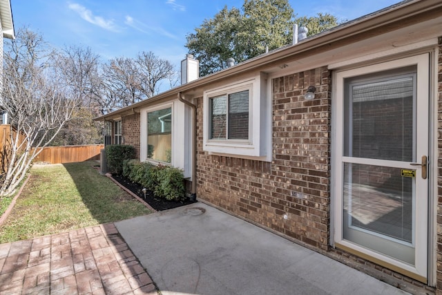 view of home's exterior with a patio and a lawn