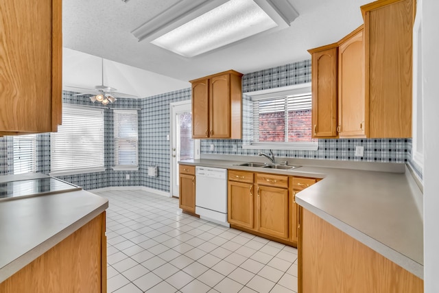 kitchen with sink, light tile patterned floors, dishwasher, and ceiling fan