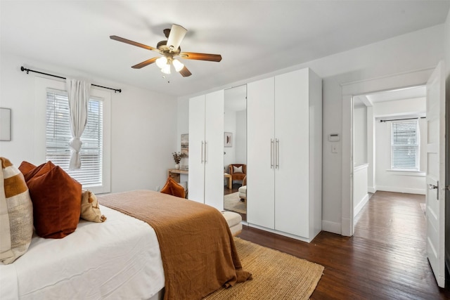 bedroom with ceiling fan and dark hardwood / wood-style flooring