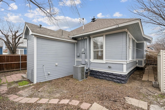 rear view of house with central AC unit