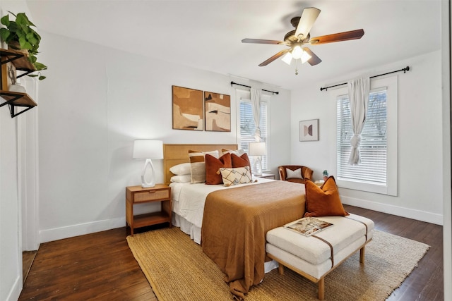 bedroom with dark hardwood / wood-style floors and ceiling fan