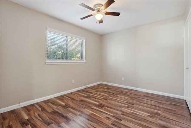 spare room featuring dark wood-type flooring and ceiling fan