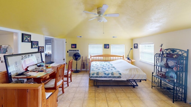 bedroom featuring light tile patterned flooring, ceiling fan, and a wall unit AC