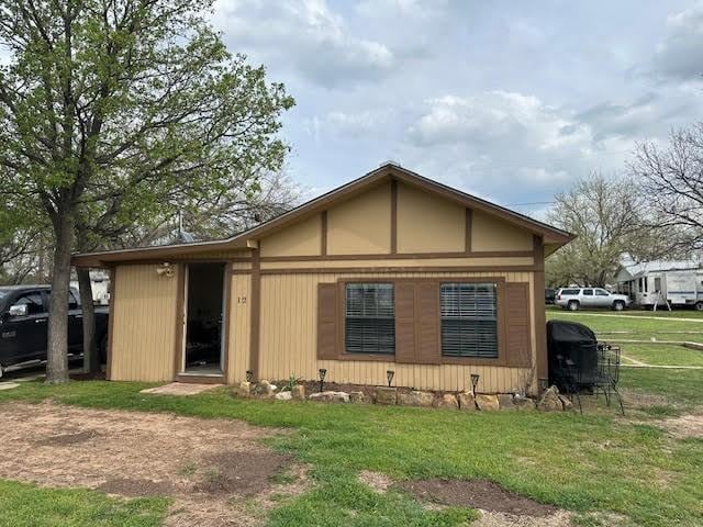 rear view of property featuring a yard