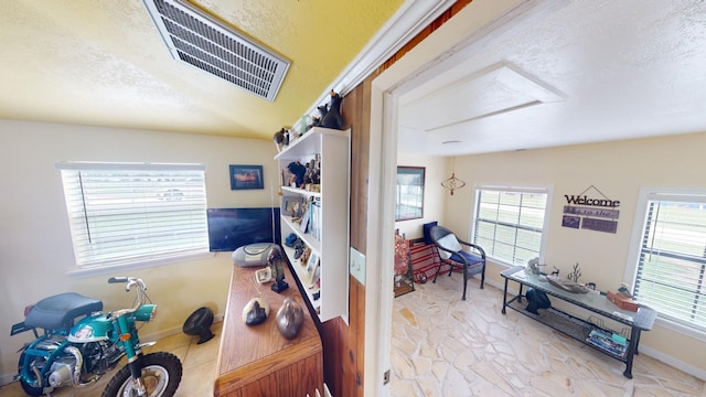 office space featuring a healthy amount of sunlight and a textured ceiling