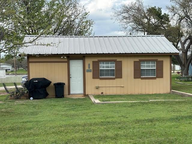 view of outbuilding with a lawn