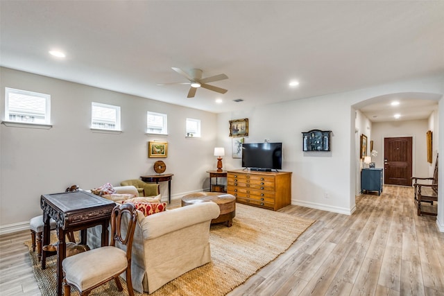 living room featuring light hardwood / wood-style floors and ceiling fan