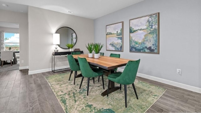 dining space with dark hardwood / wood-style flooring