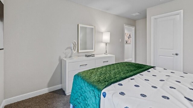 bedroom featuring dark colored carpet