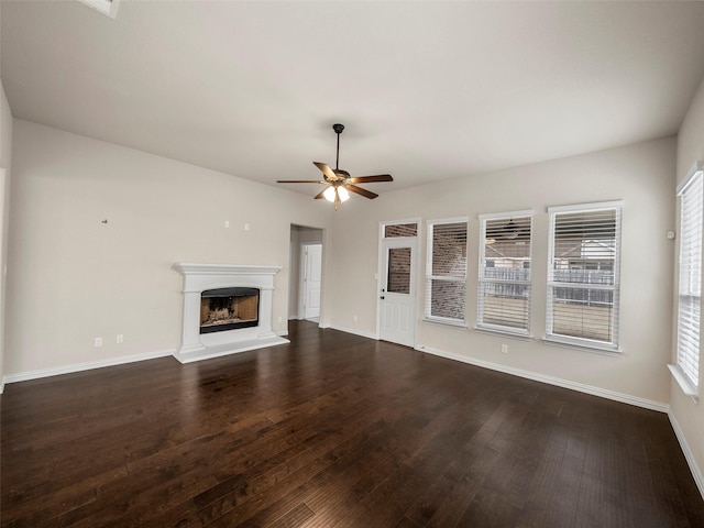 unfurnished living room with ceiling fan and dark hardwood / wood-style flooring