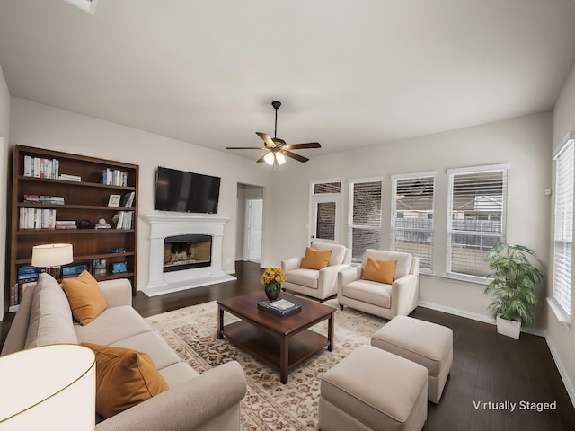 living room with wood-type flooring and ceiling fan