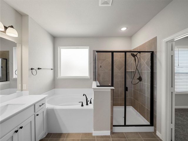 bathroom with vanity, a wealth of natural light, tile patterned floors, and shower with separate bathtub