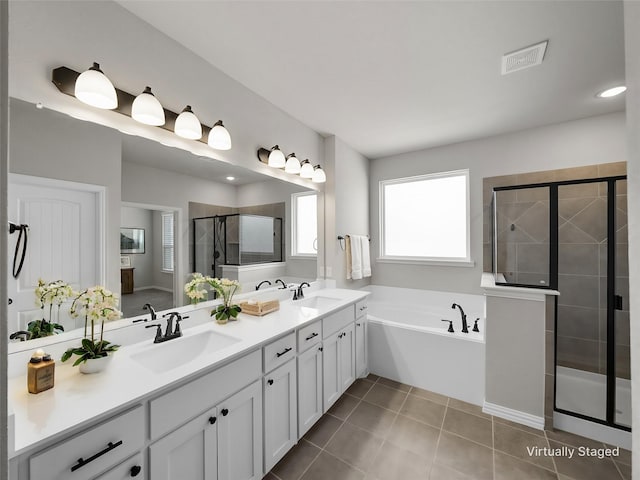 bathroom featuring vanity, tile patterned floors, and separate shower and tub