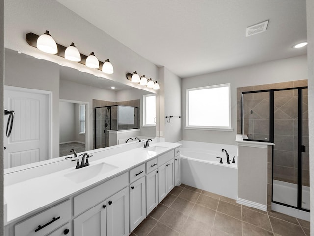 bathroom featuring vanity, plus walk in shower, and tile patterned flooring