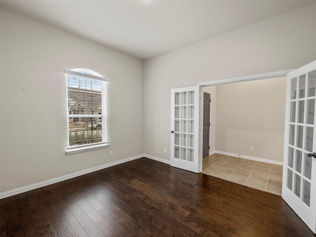 spare room featuring hardwood / wood-style flooring and french doors