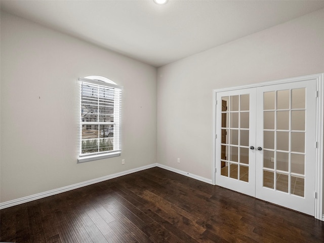 spare room with french doors and dark wood-type flooring