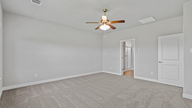 carpeted spare room featuring ceiling fan