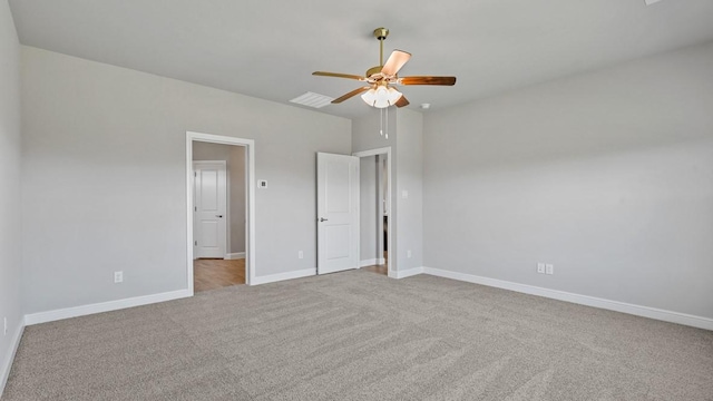 unfurnished bedroom featuring light carpet and ceiling fan