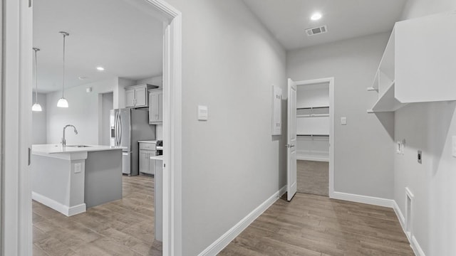 interior space featuring sink and light wood-type flooring